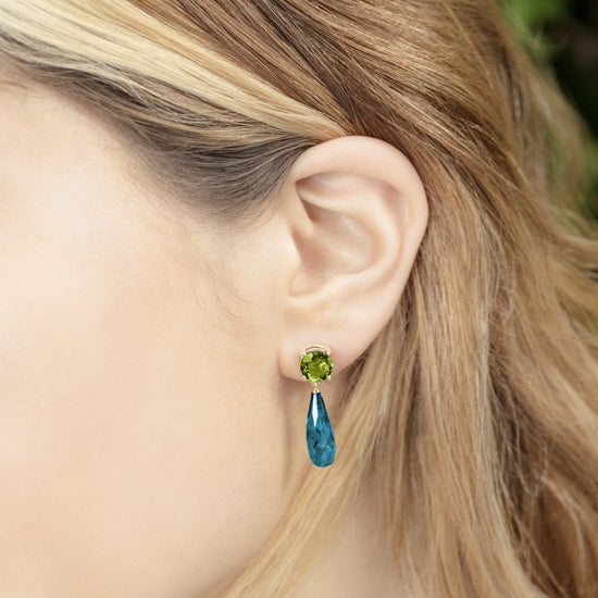 British Jewellers designed London-made custom gold jewellery – Close up of the model demonstrating the wear of the Teal Topaz and Peridot Gold Drop Earrings  – Como Collection, Augustine Jewellery, British Jewellers, Gemstone Jewellery, Luxury Jewellery London.