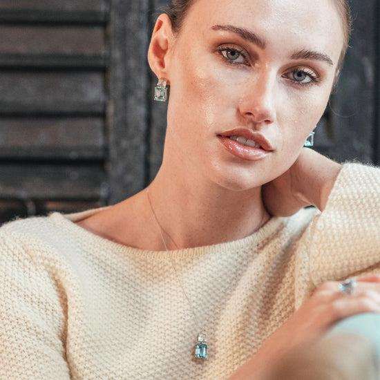 Model wearing Octagon White Gold Necklace in White Topaz & Blue Topaz