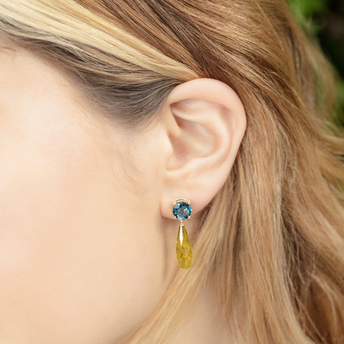 British Jewellers designed London-made custom gold jewellery - Close up of the model demonstrating the wear of the Teal Topaz and Citrine Gold Drop Earrings – Como Collection, Augustine Jewellery, British Jewellers, Gemstone Jewellery, Luxury Jewellery London.