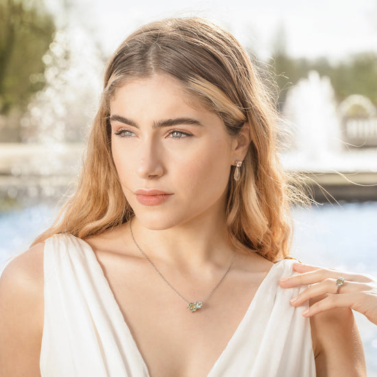 British Jewellers designed London-made custom gold jewellery – Model demonstrating the wear of the Green Amethyst and Morganite Drop Earrings and the Green Amethyst Silver Cluster Necklace – Como Collection, Augustine Jewellery, British Jewellers, Gemstone Jewellery, Luxury Jewellery London.