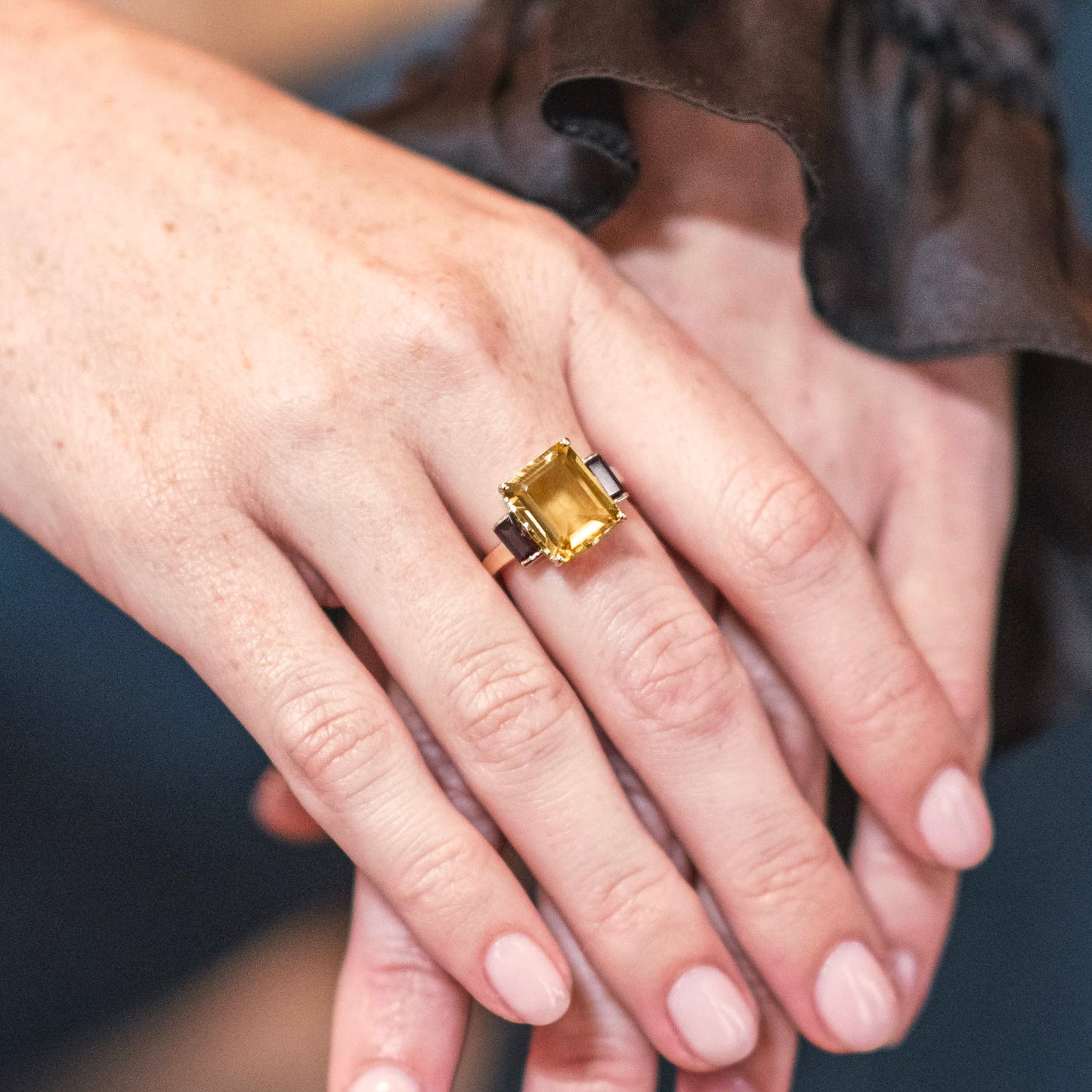 London-made luxury custom gold jewellery – Close up of Model demonstrating the wear of the 9ct Yellow Gold Octagon Ring in Smokey Quartz and Citrine, – Andalusian Collection, Augustine Jewellery, British Jewellers, Gemstone Jewellery, Luxury Jewellery London.